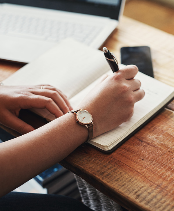 Person writing with pen