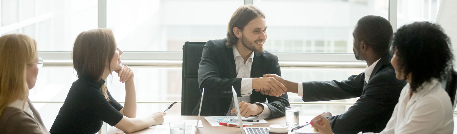 coworkers shaking hands in a conference room