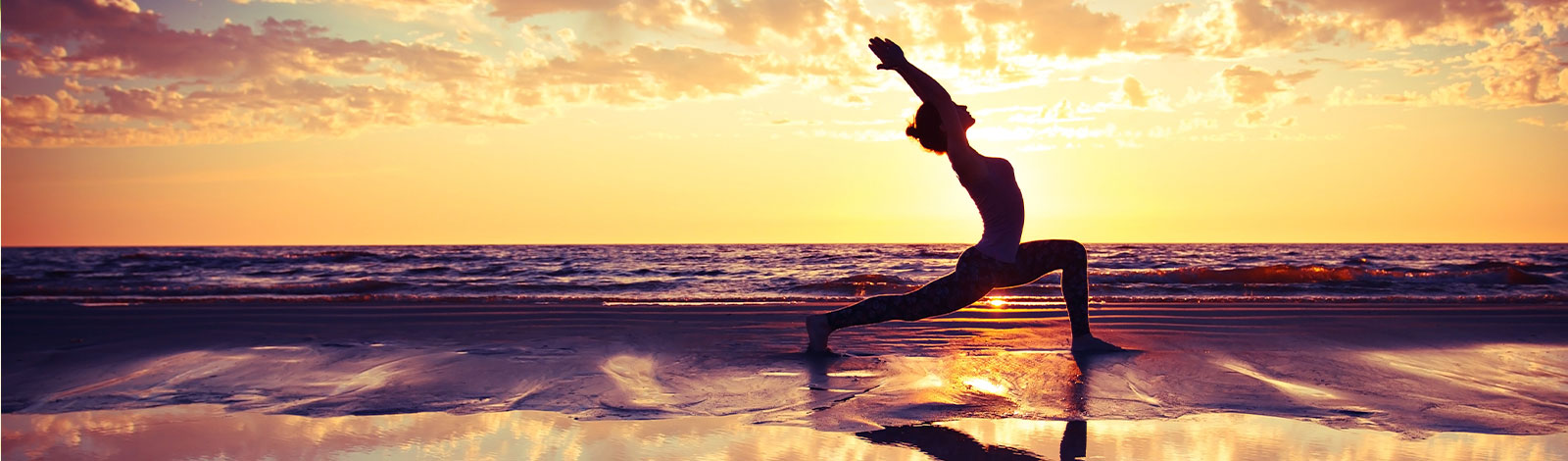 person doing yoga on the beach