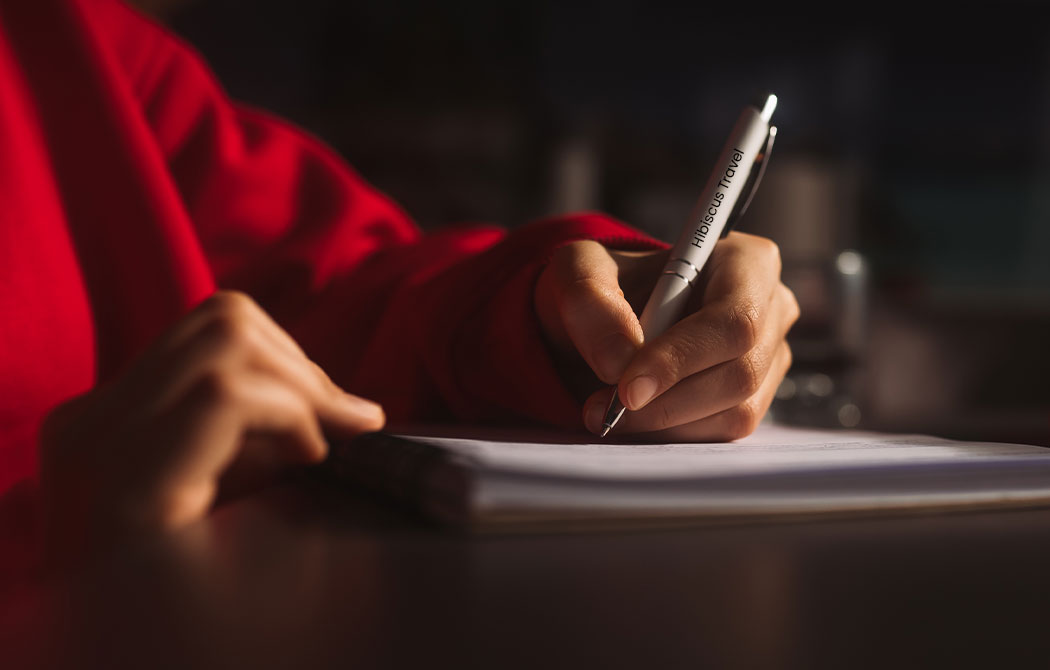 person writing with a pen