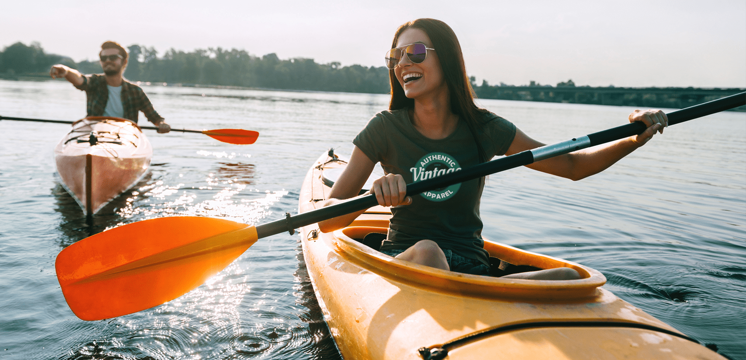 couple kayaking wearing logoed t-shirts